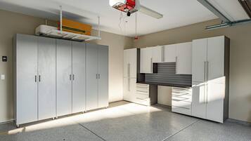 A spacious room with large cabinets, a ceiling fan, and a visible ductwork system.