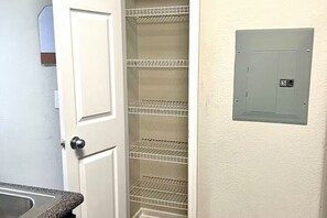 A kitchen with a countertop and a white door.
