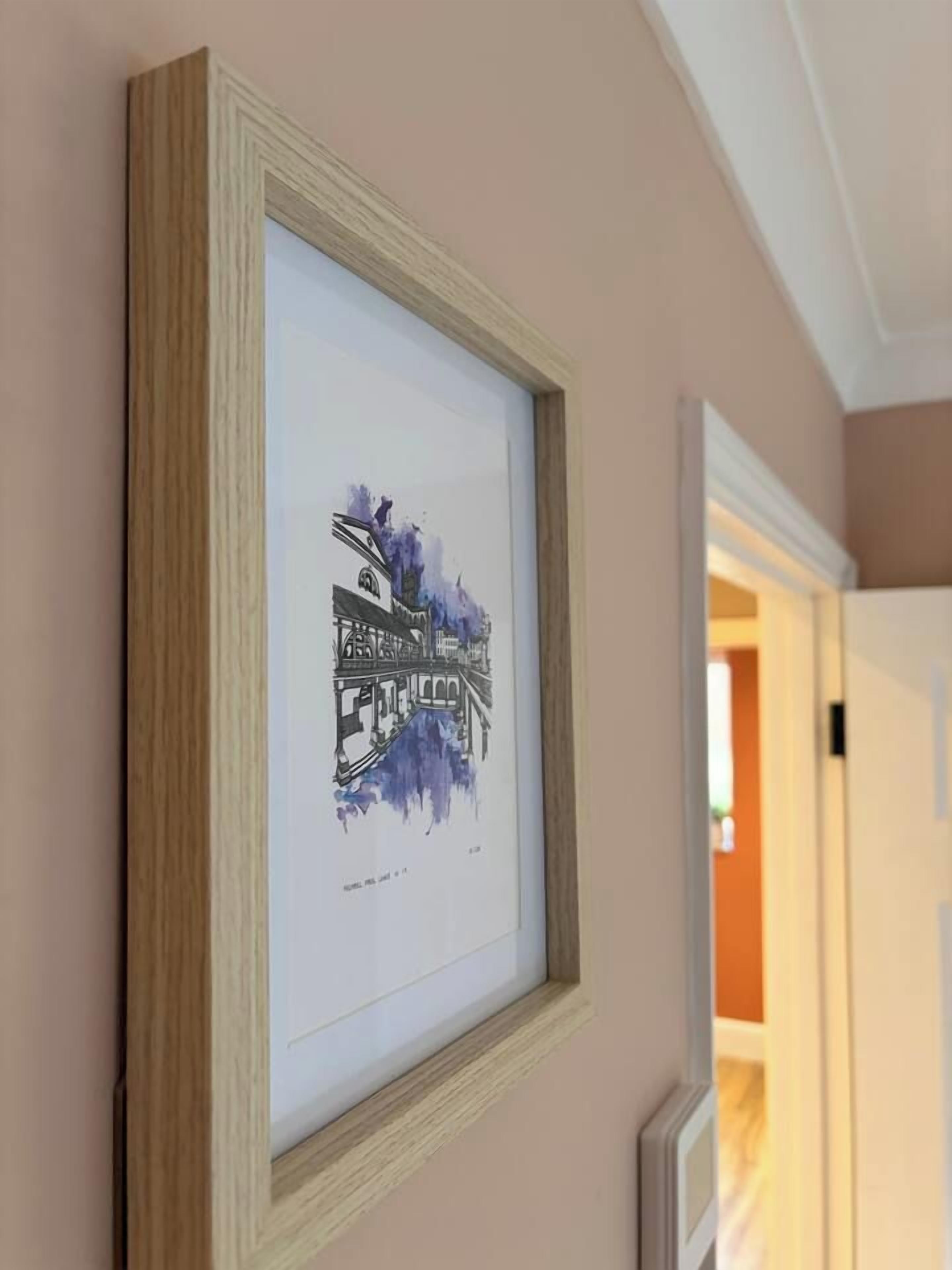 A framed artwork on a wall.