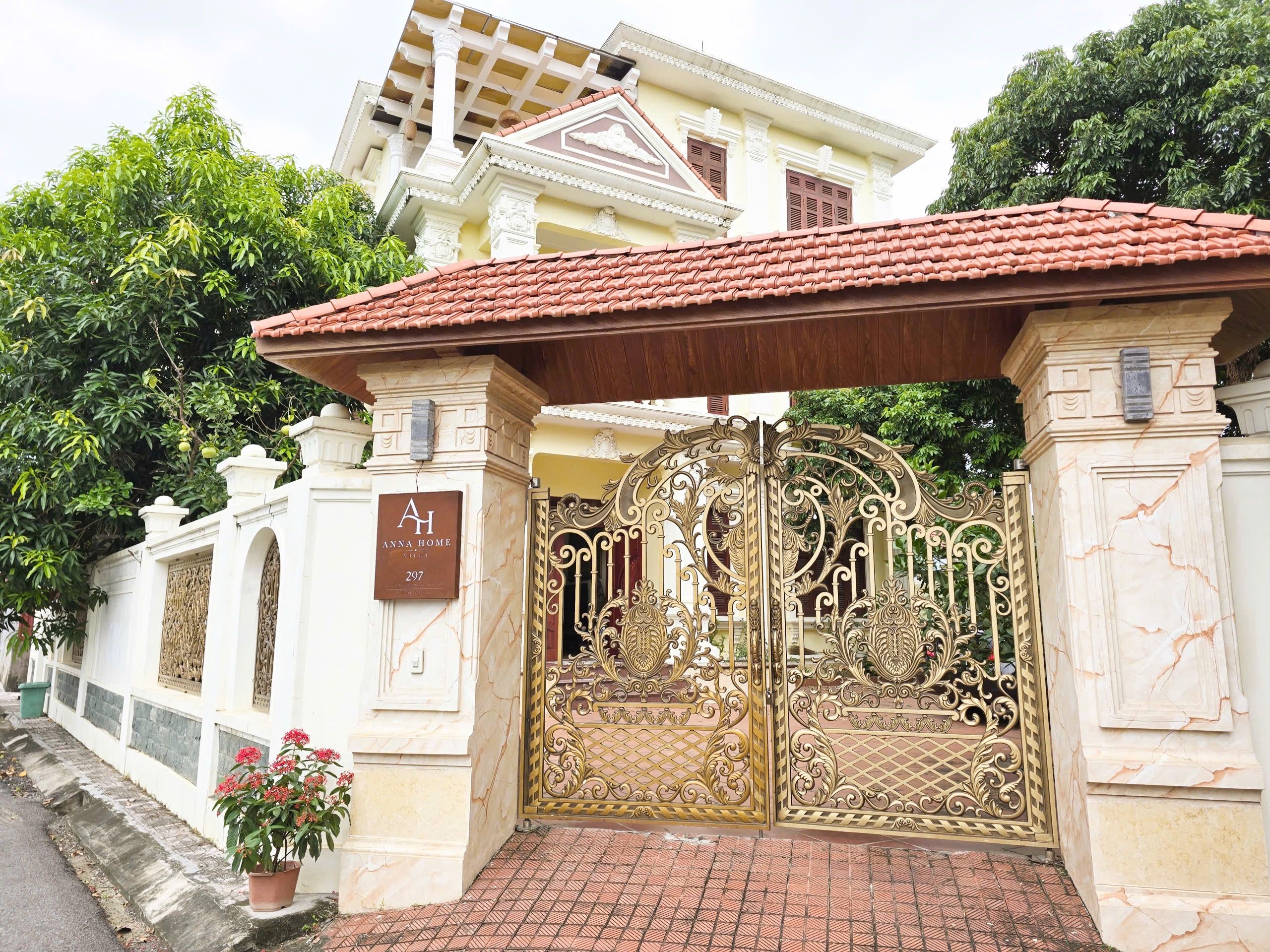 A gated entrance with a sign indicating 'ANNA HOME' and a number '297'.