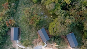An aerial view of a property with three buildings, surrounded by dense forest. - Casa Jaguar Number 1 (Monteverde)
