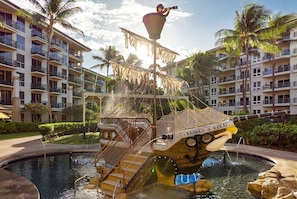 A water fountain with a pirate ship design, surrounded by palm trees and hotel buildings. - Connect with the beauty of Maui at Westin Ka'anapali Ocean Resort Villas North (Lahaina)