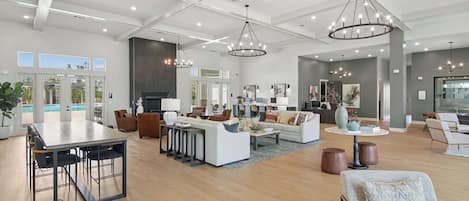 A spacious living area with a dining table, sofas, and a fireplace.