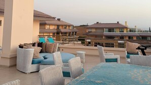 An outdoor seating area with wicker furniture and a large umbrella. - Best Sea View in Morocco, Wheelchair Friendly, Plage des Nations, Rabat, Kénitra (Plage des Nations)