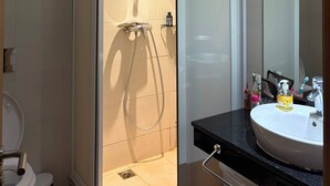 A modern bathroom with a glass-enclosed shower, a white sink, and a mirror. - Best Sea View in Morocco, Wheelchair Friendly, Plage des Nations, Rabat, Kénitra (Plage des Nations)