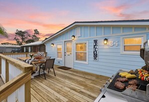 A residential property with a deck, a barbecue grill, and a welcome sign. - Saltwater Heated Pool | Kayaks |Golf Cart | Firepit | Beach (Palm Coast)