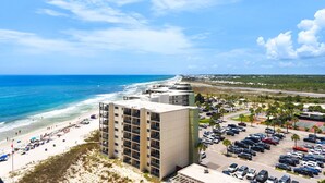 A coastal hotel with a parking lot, beach access, and ocean views. - Ocean Front Livingroom! By 30A, Beautifully Updated, Gated Community, 9th Floor (Panama City Beach)