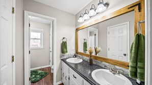 A bathroom with two sinks, a large mirror, and a shower. - Relax & Recharge  Cozy 2BR Near Fort Campbell (Clarksville)