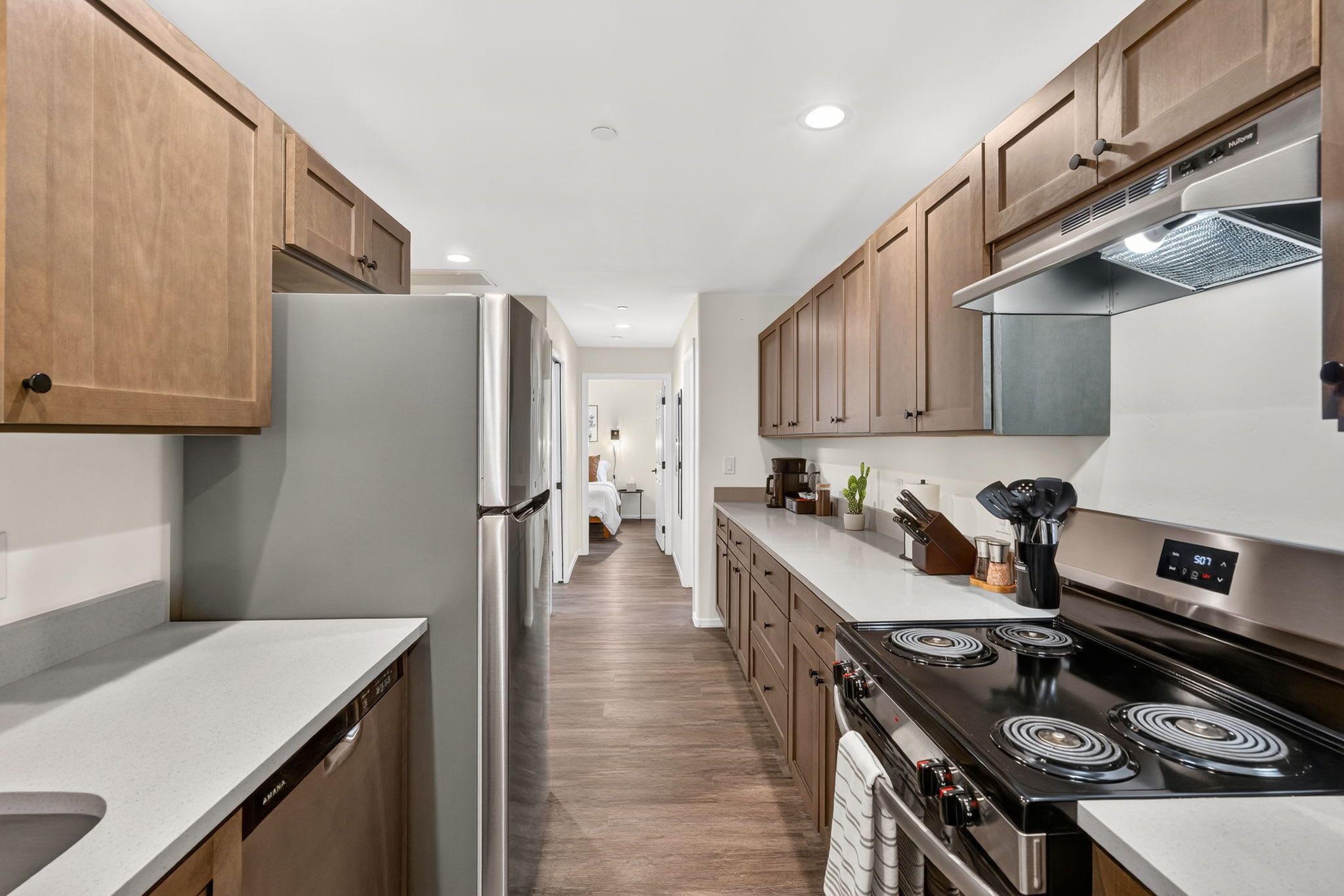 A modern kitchen with wooden cabinets, stainless steel appliances, and a central island.