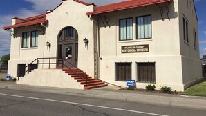 A two-story building with a red-tiled roof, a sign reading 'Franklin County Historical Museum,' and a ramp for accessibility. - Value Stay Near Tri-Cities Airport, Columbia River & Family Adventures (Pasco)