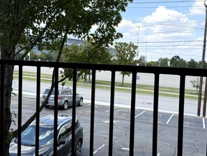 A parking lot with a black car parked in the foreground and a grey SUV in the background. - 500 Yds to AT&T Stadium Balcony 2BR Sleeps 6 (Arlington)