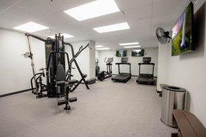 A gym with exercise equipment, treadmills, and a TV on the wall. - SC 2207 | Mountain Summer Escape with Refreshing Pool Access (Snowshoe)