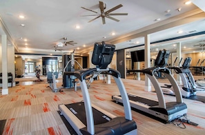 A gym with treadmills, exercise equipment, and a mirrored wall. - Landing | Amazing 1BD, Gym (Gainesville)