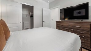 A bedroom with a bed, a wardrobe, a television, and a closet. - Landing | Beautiful 1BD in Kannapolis (Kannapolis)
