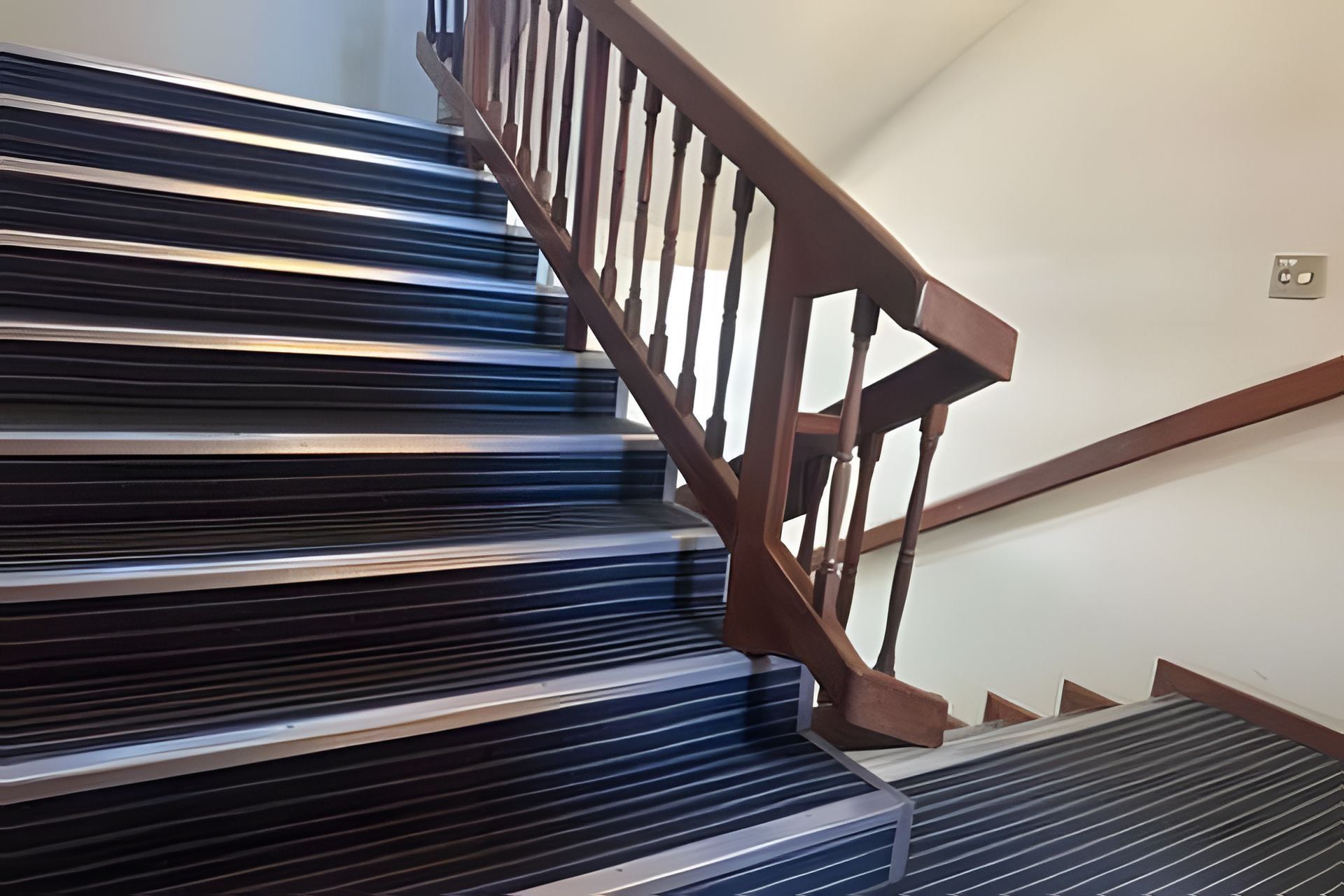A staircase with wooden handrails and metal steps.
