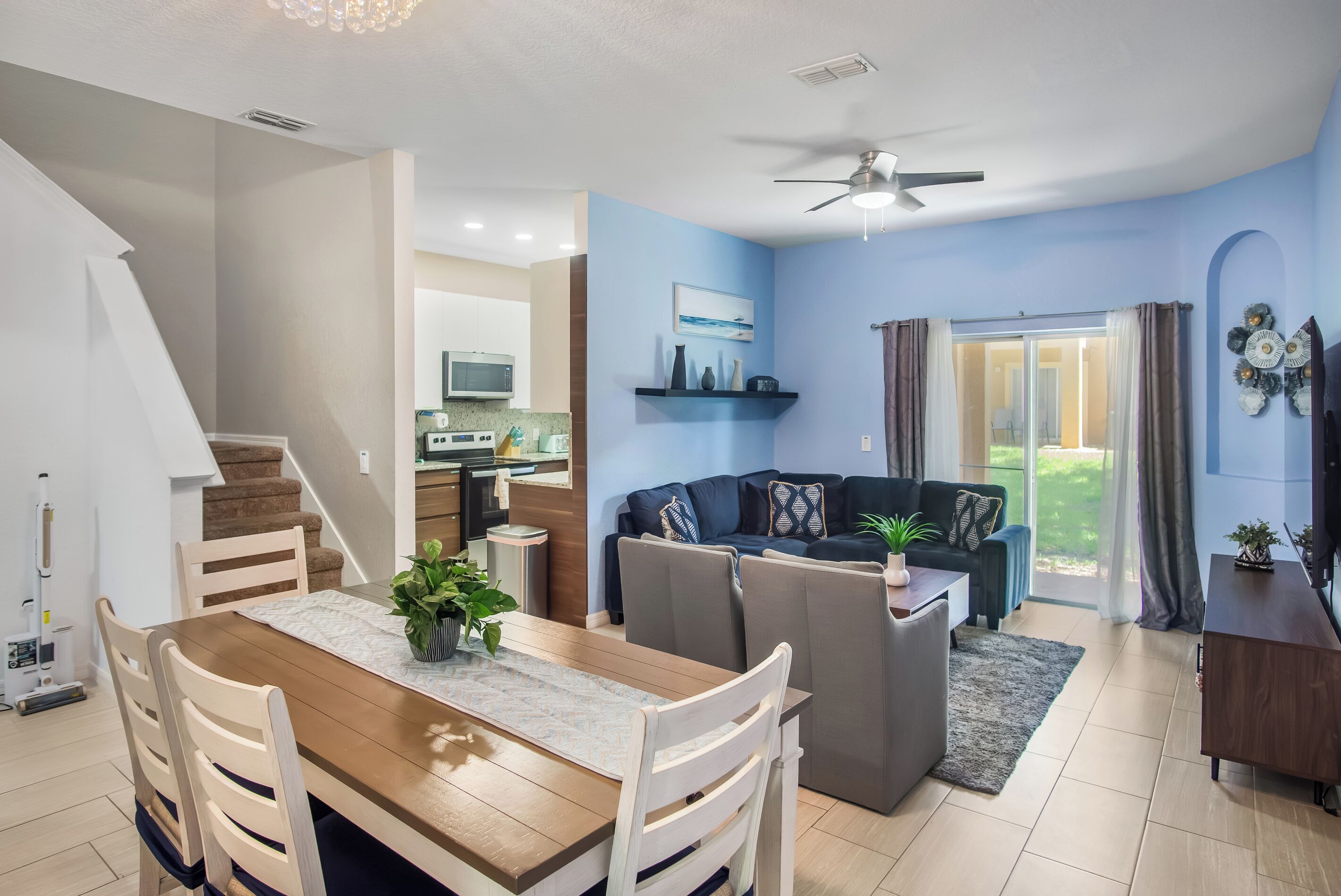 Un espacio de estar moderno con comedor, cocina y un balcón con vistas.
