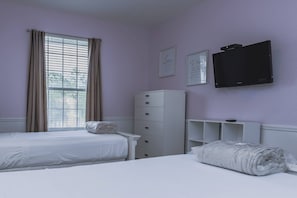 A bedroom with two beds, a wardrobe, a television, and a window with curtains. - Comfortable 3BR Vista Cay Near Universal (Orlando)