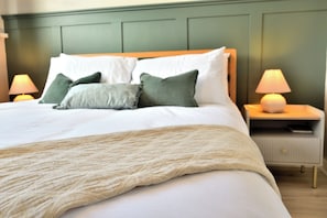 A neatly made bed with a white comforter and a beige knitted throw. - Seven Glen: stylish coastal escape near the beach (Portrush)