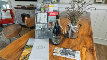 A wooden table with a wine bottle, a book titled 'Local Spots to Taste Wine,' and brochures.