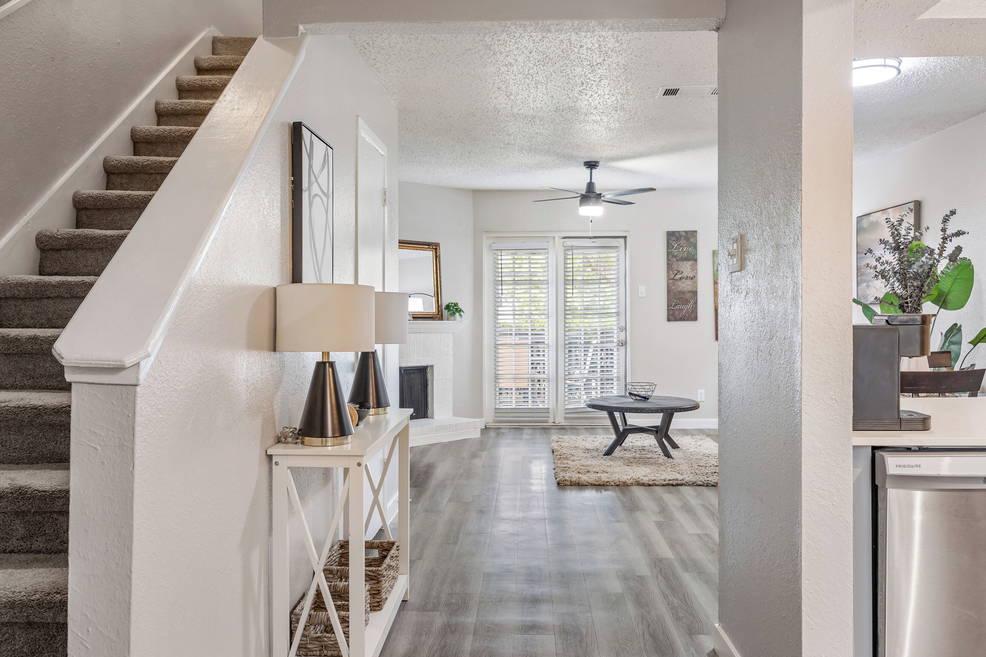A modern interior with a staircase, a dining area, and a kitchen.