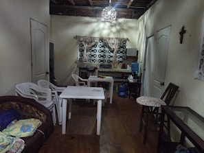 A compact living space with a dining area, a small kitchen, and a seating area with a sofa and chairs. - BLUE SEA HOUSE (Playa Blanca)