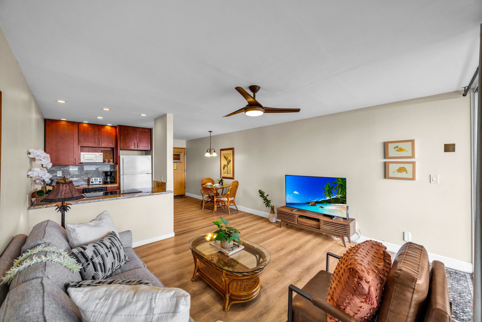 A modern living room with a sofa, a coffee table, and a television.