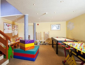 A children's play area with a foosball table, colorful play structures, and educational posters on the walls. - Holiday Apartment With Wellness Area (Laengenfeld)