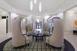 A spacious lobby with a central seating area, a patterned floor, and a modern chandelier. - Resort-Style Naples Living in Winding Cypress- Private Pool, Spa & Waterfront (Naples)