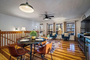 A dining area with a round table, chairs, and a ceiling fan. - Locklyn's Loft Views, Hot Tub, Game Room & MORE! (Gatlinburg)