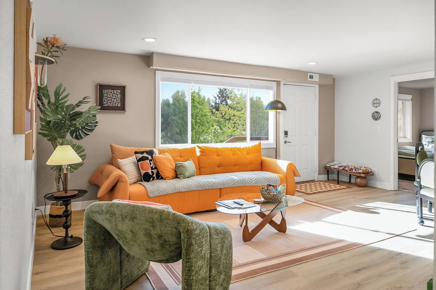 A modern living room with a sofa, a coffee table, and a lamp.