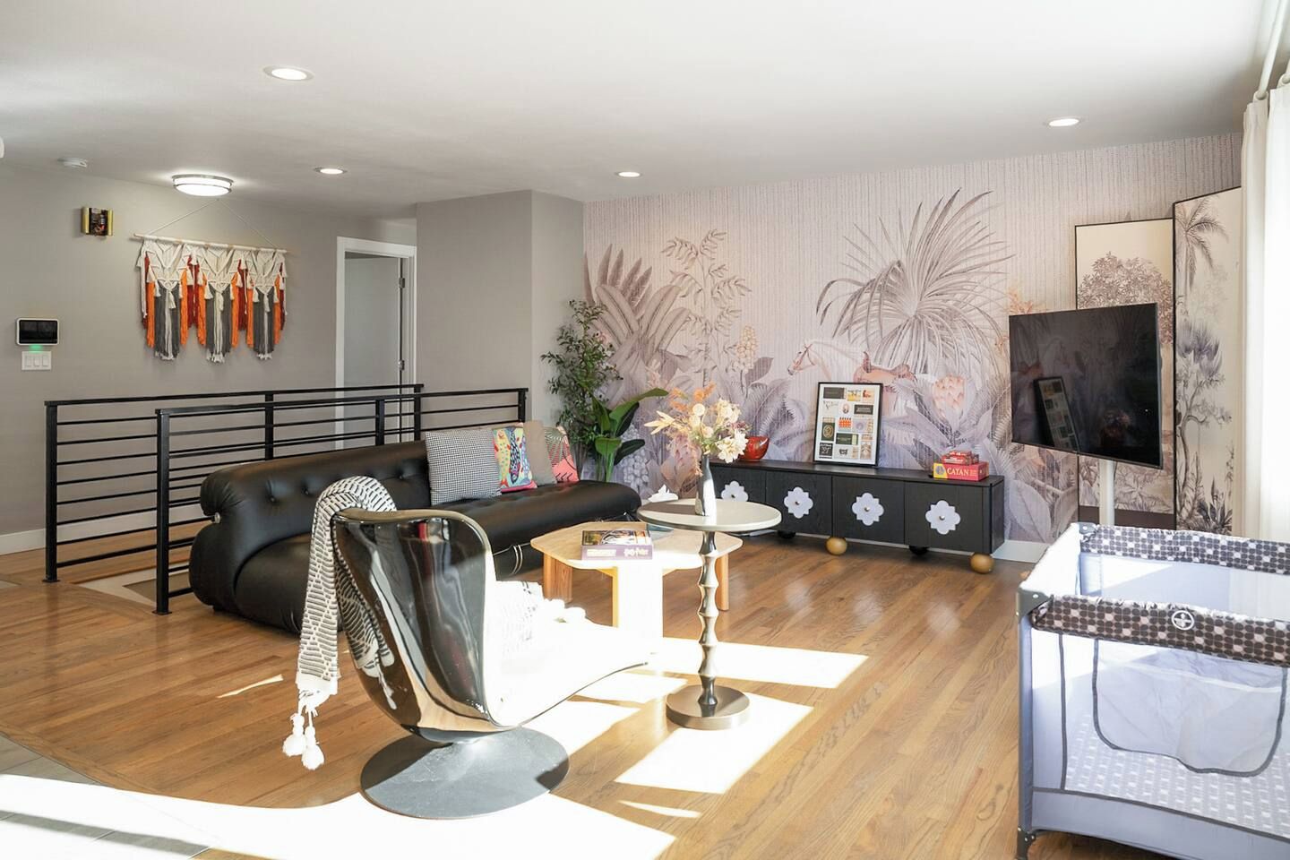 A modern living room with a sofa, coffee table, and decorative plants.