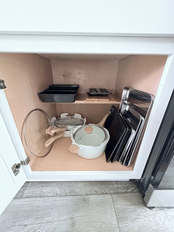A kitchen with a built-in oven, a microwave, and a sink.