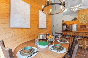 A wooden dining room with a round table set for four, featuring a chandelier, wall art, and a kitchen in the background. - +Keystone Mountain Cabin
 7 min walk to ski lift / walk in/out


Share

Save (Keystone)