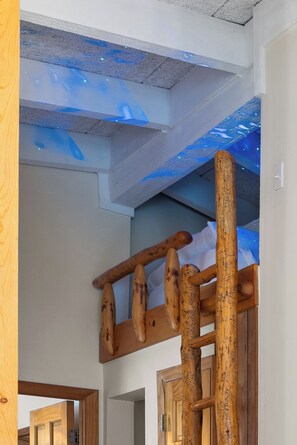 A wooden staircase with a unique design, leading to a room with a ceiling that has a textured finish and blue lighting accents. - +Keystone Mountain Cabin
 7 min walk to ski lift / walk in/out


Share

Save (Keystone)