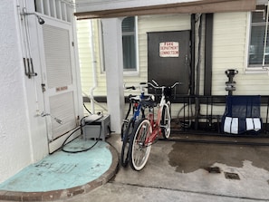 A building entrance with a fire department connection sign, a pool heater, and bicycles parked outside. - Lovely 1-bedroom condo with pool in lovely Wildwood right by beach and boardwalk (Wildwood)