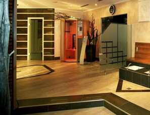 A hotel lobby with a reception desk, a staircase, and a wall-mounted clock. - Holiday Apartment With Wellness Area (Laengenfeld)