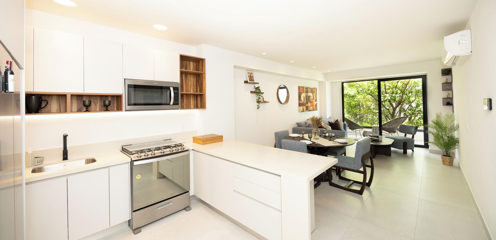 A modern kitchen with a built-in stove, microwave, and wooden shelves.