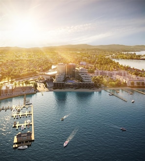 A waterfront property with multiple buildings, a marina, and a river. - 909 Aqua 1 Resort Condo | Panoramic Okanagan Views (Kelowna)