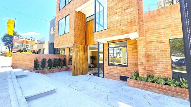A modern two-story building with a brick facade, large windows, and a visible entrance. - Vista Hermosa neighborhood, Quito, near the U.S. Embassy and Solca Hospital (Quito)