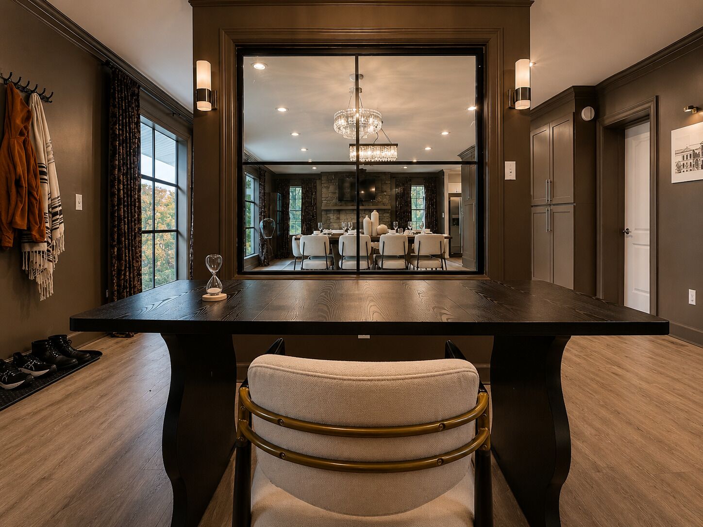 A dining area with a large table, chairs, and a view into a kitchen and dining room.