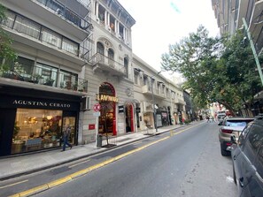 A street view with a building featuring a storefront named 'Landmark.' - 10- Incredible Apt. Privileged Location Recoleta (Buenos Aires)