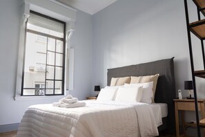 A bedroom with a bed, a window, a bedside table, and a lamp. - 10- Incredible Apt. Privileged Location Recoleta (Buenos Aires)