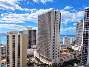 A high-rise hotel with multiple floors, a pool, and a view of the ocean. - 23F-Waikiki Gem-1BR Condo with Diamond Head & Ocean Views (Honolulu)