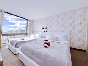 A hotel room with two beds, a large window, and a city view. - 23F-Waikiki Gem-1BR Condo with Diamond Head & Ocean Views (Honolulu)