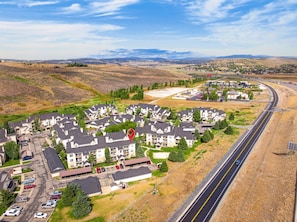A residential area with multi-story houses, a parking lot, and a highway. - Cute Updated 1BR Condo in Park City, 30 Night Min (Park City)