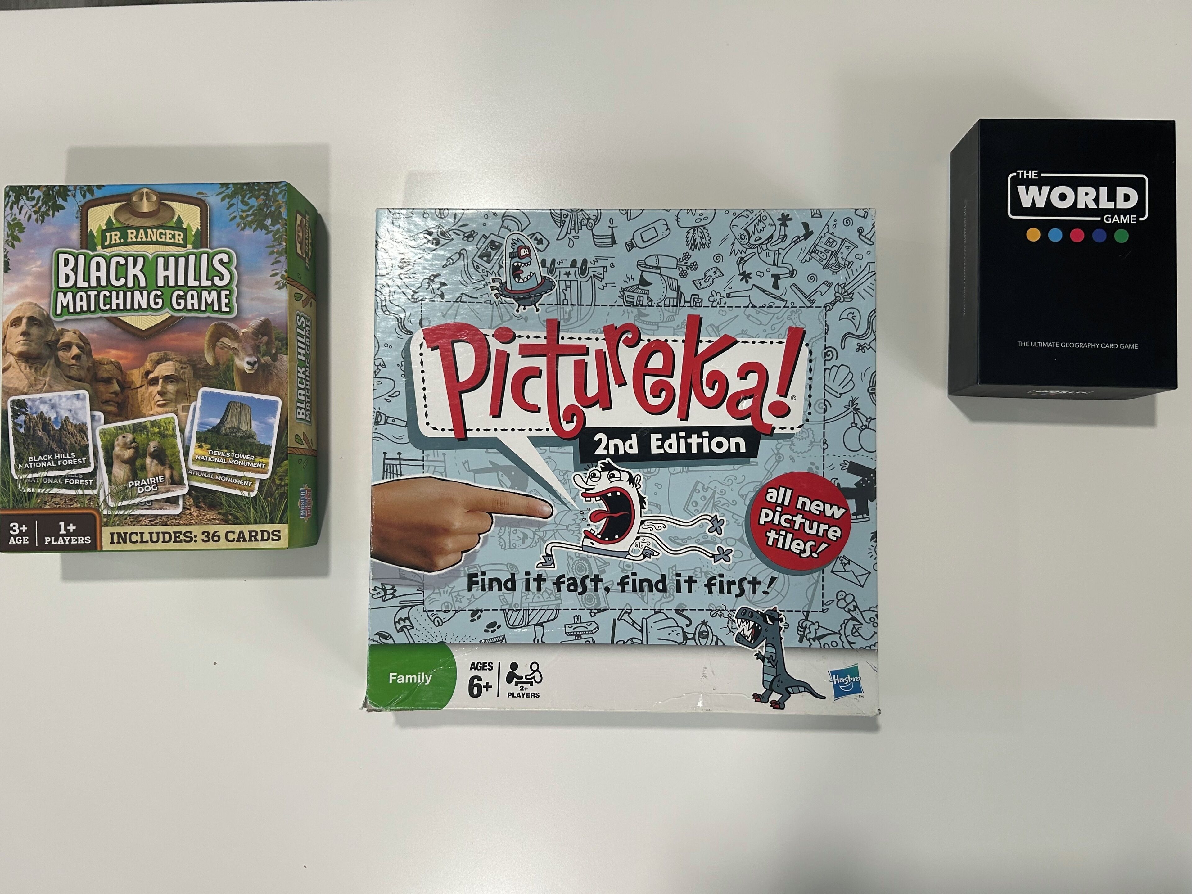 Three board games: 'Black Hills Matching Game,' 'Pictureka! 2nd Edition,' and 'The World Game.'