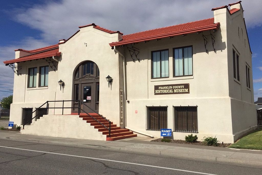 A two-story building with a red-tiled roof, a sign reading 'Franklin County Historical Museum,' and a ramp for accessibility.
