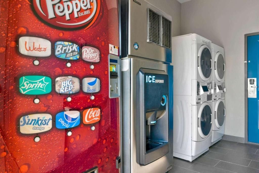 A vending machine with various beverage options and a washing machine.