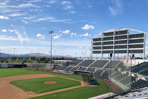 A baseball stadium with multiple seating tiers, a large scoreboard, and a clear sky. - 2 Units of 2 Queen Beds Perfect for Group Stays l Close to Riverfront Walks (Pasco)