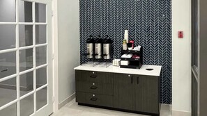 A room with a minibar, a door with frosted glass panels, and a patterned wallpaper. - Budget-Friendly Room | Free Parking, Pets Allowed | Durst Taylor Museum - 2.4 mi (Nacogdoches)
